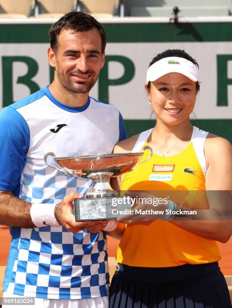 Latisha Chan of Chinese Taipei and partner Ivan Dodig of Croatia pose with the trophy as they celebrate victory following the mixed doubles Final...