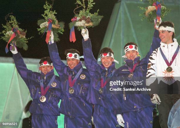 Takanobu Okabe, Noriaki Kasai, Masahiko Harada and Jinya Nishikawa pose on the podium after winning silver medals in the Ski Jumping Team during the...