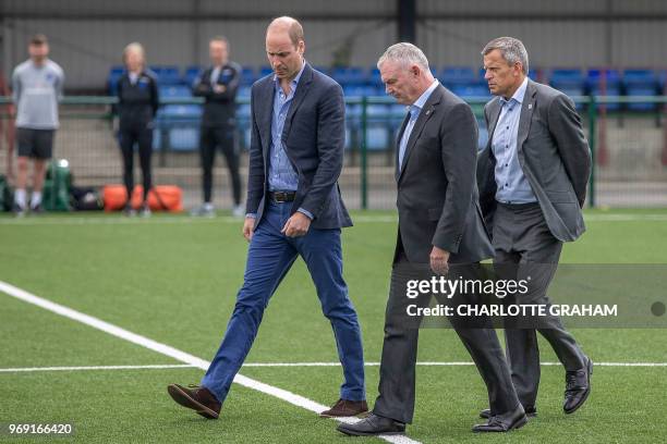 Britain's Prince William, Duke of Cambridge , President of the Football Association speaks with FA chief executive, Martin Glenn and FA chairman,...