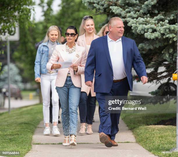 Ontario PC Leader Doug Ford walks with his wife Karla and family to St. George's Junior School Polling Station 28 in Etobicoke to cast his vote in...