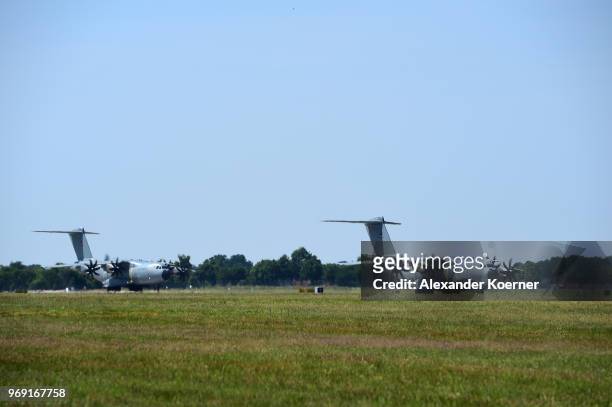 Two Airbus A400M transport planes of the Bundeswehr, the German armed forces, fly in formation at Fliegerhorst Wunstorf to take part in an open house...