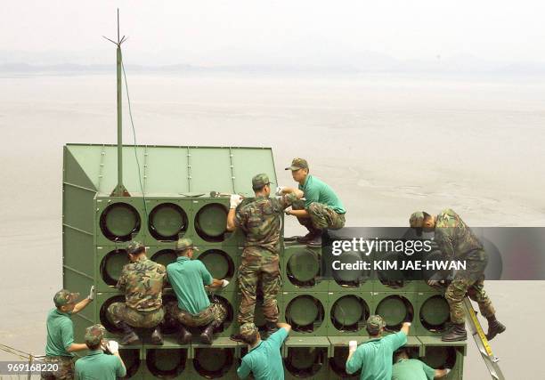 South Korean soldier tear down a battery of propaganda loudspeakers along the border with North Korea in Paju on 16 June 2004. The dismantlement...