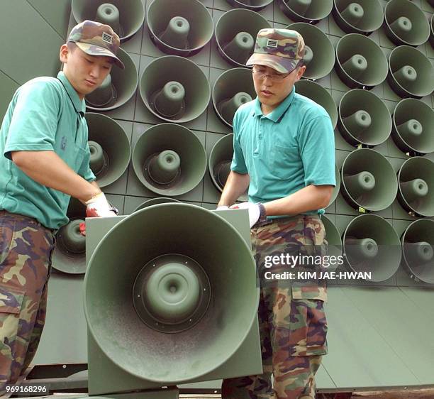 South Korean soldier take down a battery of propaganda loudspeakers along the border with North Korea in Paju on 16 June 2004. The dismantlement...