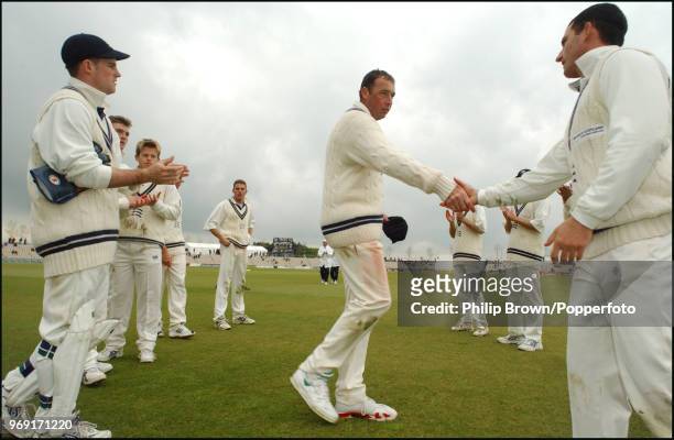 Angus Fraser shakes hands with his Middlesex teammates during his last game for Middlesex, a Benson and Hedges Cup group match against Hampshire at...