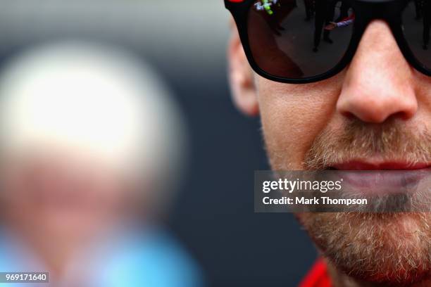 Sebastian Vettel of Germany and Ferrari looks on in the Paddock during previews ahead of the Canadian Formula One Grand Prix at Circuit Gilles...