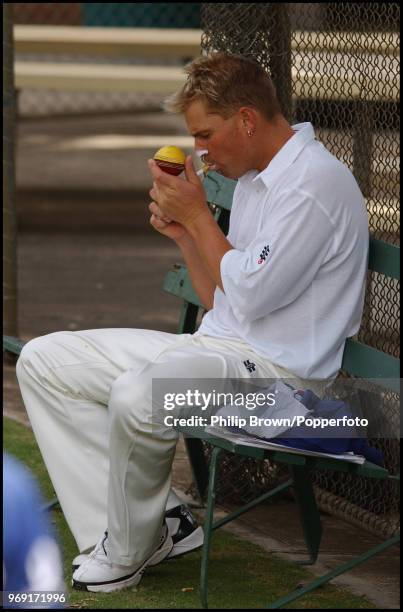 Shane Warne of Australia stops for a cigarette during a training session before the 2nd Test match between Australia and England at the Adelaide...