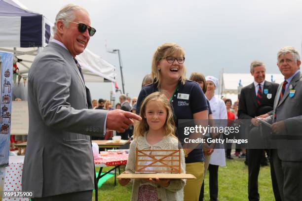 Prince Charles, Prince of Wales is seen with Delilah Cresswell, winner of the selfie frame competition, that will link 6 of the show's educational...