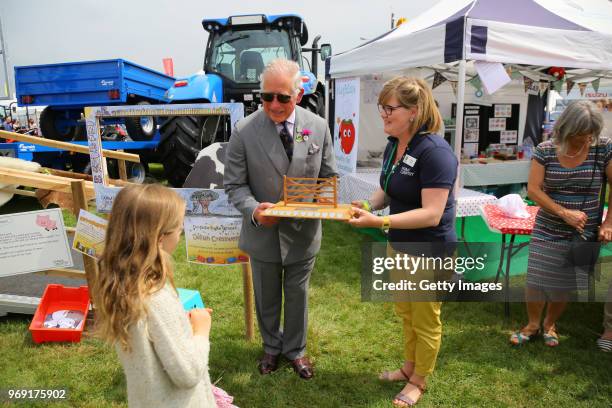 Prince Charles, Prince of Wales presents Delilah Cresswell, winner of the selfie frame competition, that will link 6 of the show's educational videos...