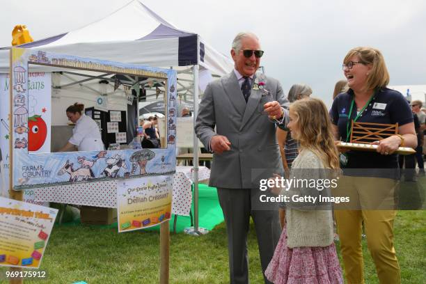 Prince Charles, Prince of Wales is seen with Delilah Cresswell, winner of the selfie frame competition, that will link 6 of the show's educational...