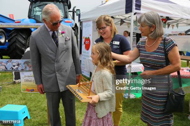 Prince Charles, Prince of Wales is seen with Delilah Cresswell, winner of the selfie frame competition, that will link 6 of the show's educational...