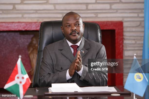 Burundi's President Pierre Nkurunziza reacts after signing for a new constitution adopted by a referendum in Gitega, on June 7, 2018. - The...