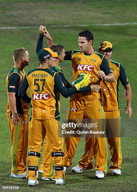 Shaun Tait of Australia is congratulated by team-mates after getting a wicket during the Twenty20 International match between Australia and the West...