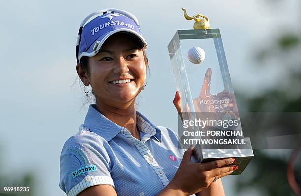 Ai Miyazato of Japan holds with winner's trophy following her victory in the final round of the Golf Honda PTT LPGA Thailand 2010 golf tournament at...