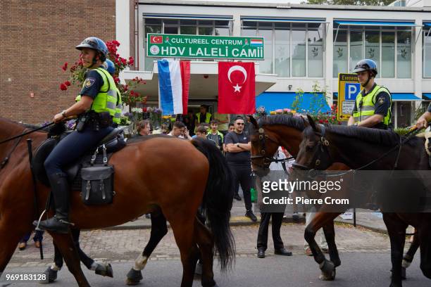 Police officers on horses pass by the Laleli Mosque on June 7, 2018 in Rotterdam, Netherlands.The anti-Islam group Pegida plans to roast pigs on a...