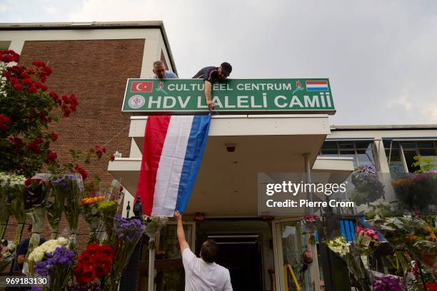 Members of the Laleli Mosque hand a Dutch flag on June 7, 2018 in Rotterdam, Netherlands.The anti-Islam group Pegida plans to roast pigs on a...