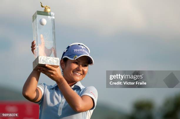 Ai Miyazato of Japan poses with the trophy after winning the final round of the Honda PTT LPGA Thailand at Siam Country Club on February 21, 2010 in...