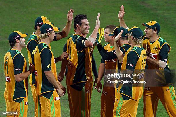 Shaun Tait of Australia is congratulated by team-mates after getting a wicket during the Twenty20 International match between Australia and the West...