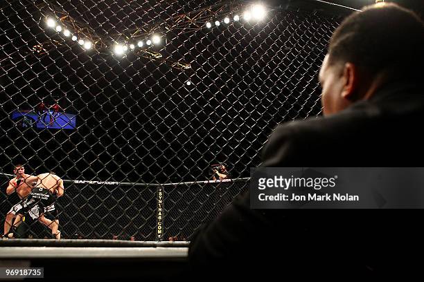 A judge watches on as UFC fighter George Sotiropoulos battles UFC fighter Joe Stevenson during their Ultimate Fighting Championship lightweight fight...