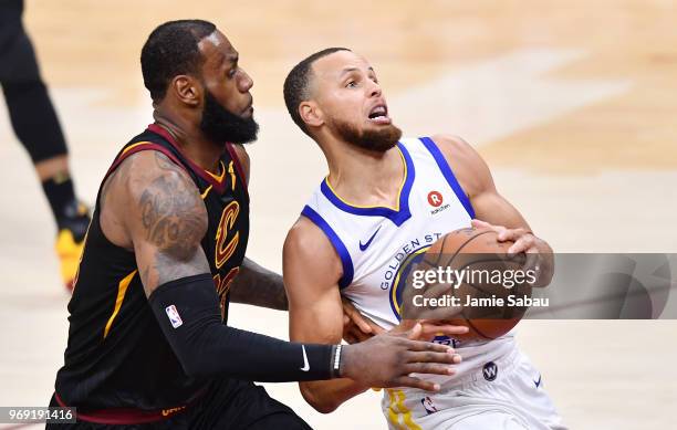 Stephen Curry of the Golden State Warriors goes up against LeBron James of the Cleveland Cavaliers during Game Three of the 2018 NBA Finals at...