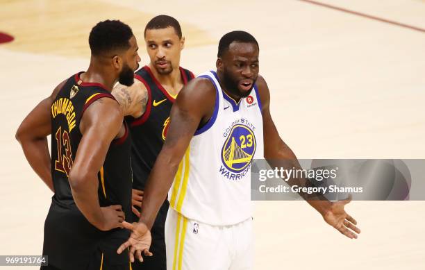 Draymond Green of the Golden State Warriors reacts as Tristan Thompson and George Hill of the Cleveland Cavaliers look on during Game Three of the...