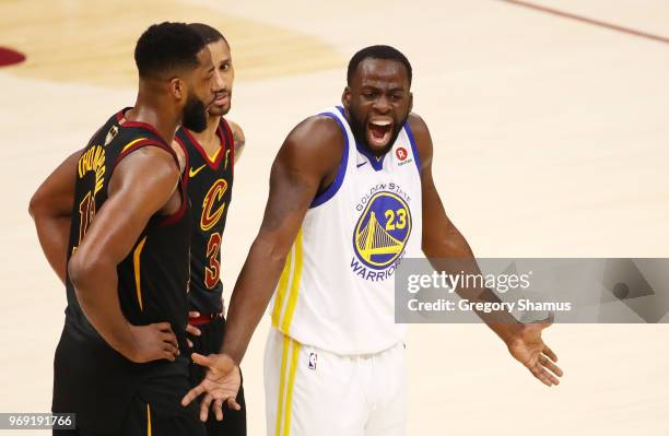 Draymond Green of the Golden State Warriors reacts as Tristan Thompson and George Hill of the Cleveland Cavaliers look on during Game Three of the...