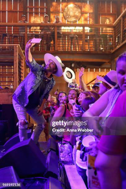 Preston Brust of LOCASH takes a selfie onstage in the HGTV Lodge at CMA Music Fest on June 7, 2018 in Nashville, Tennessee.