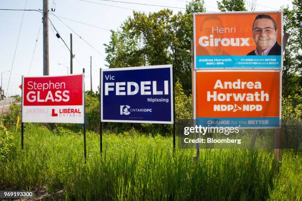 Signs for Nipissing candidates Stephen Glass, Ontario Liberal Party candidate, Vic Fedeli, leader of the Progressive Conservative Party of Ontario,...