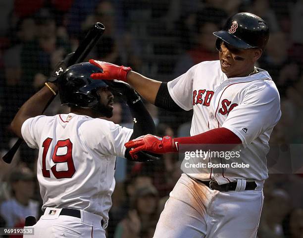 Boston Red Sox third baseman Rafael Devers is greeted at home plate as he scores during a four run third inning. The Boston Red Sox host the Detroit...