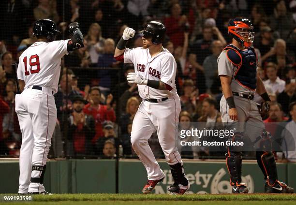 Boston Red Sox catcher Christian Vazquez is greeted by Boston Red Sox center fielder Jackie Bradley Jr. After his solo home run in the seventh...