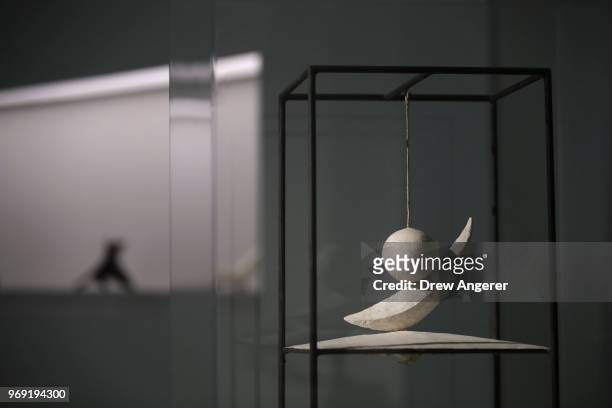Suspended Ball,' a metal, cord, and plaster sculpture from 1931, is displayed at a retrospective exhibition of work by Swiss sculptor and artist...