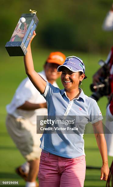 Ai Miyazato of Japan celebrates with the trophy after winning the final round of the Honda PTT LPGA Thailand at Siam Country Club on February 21,...