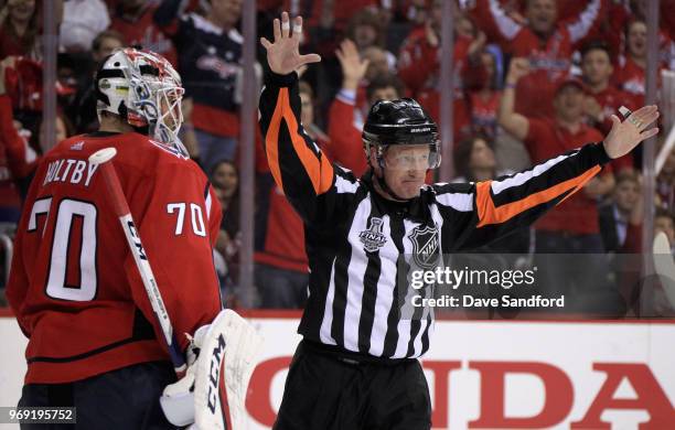 Referee Kelly Sutherland motions near goaltender Braden Holtby of the Washington Capitals during the second period of Game Four of the 2018 NHL...