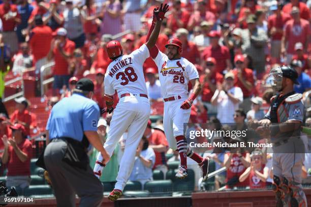 Jose Martinez and Tommy Pham both of the St. Louis Cardinals celebrate a two run in the in the first inning against the Miami Marlins at Busch...