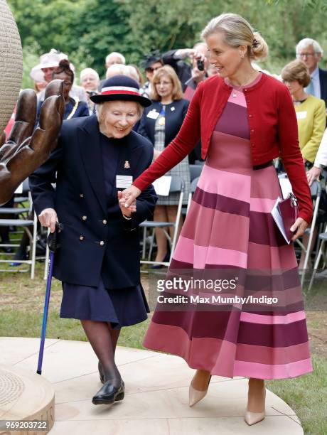 Sophie, Countess of Wessex holds hands with Margaret Bearley, a former Voluntary Aid Detachment Nurse, as she attends a service of dedication for a...