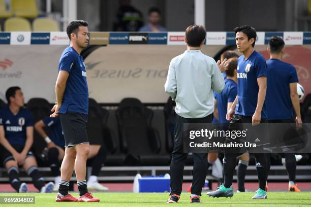 Head coach Akira Nishino talks with Maya Yoshida and Makoto Hasebe of japan during a training session ahead of the international friendly match...