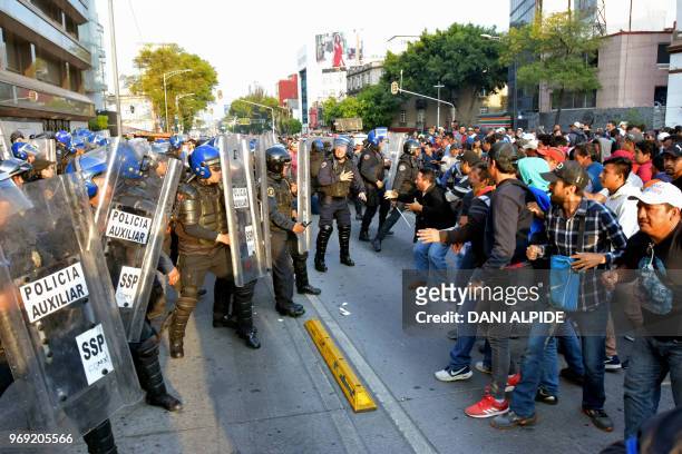 Teachers from across Mexico clash with police during a protest against the education reform and to demand the release of colleagues arrested in...