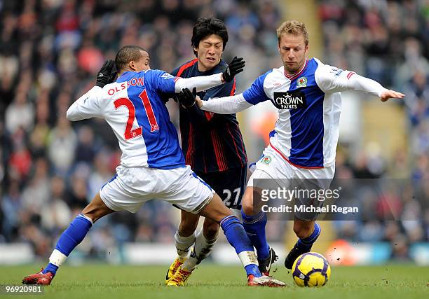 Martin Olsson and Vince Grella of Blackburn challenge Chung-Yong Lee of Bolton during the Barclays Premier League match between Blackburn Rovers and...