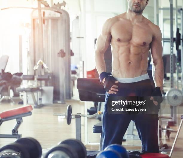 fitness instructor posing in health club with dumbbell - protein shaker stock pictures, royalty-free photos & images