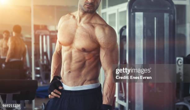 fitness instructor posing in health club with dumbbell - protein shaker stock pictures, royalty-free photos & images