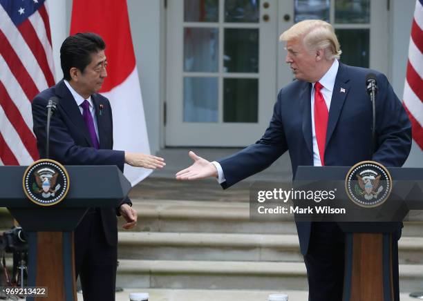 President Donald Trump and Japanese Prime Minister Shinzo Abe shake hands as they speak to the media during a news conference in the Rose Garden at...