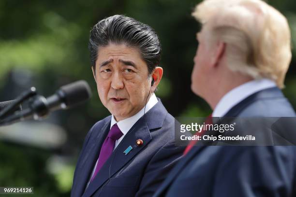 Japanese Prime Minister Shinzo Abe looks at U.S. President Donald Trump at a joint news conference in the Rose Garden at the White House June 7, 2018...