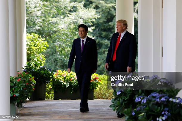 President Donald Trump and Prime Minister of Japan Shinzo Abe walk out from the Oval Office before their joint news conference in the Rose Garden of...