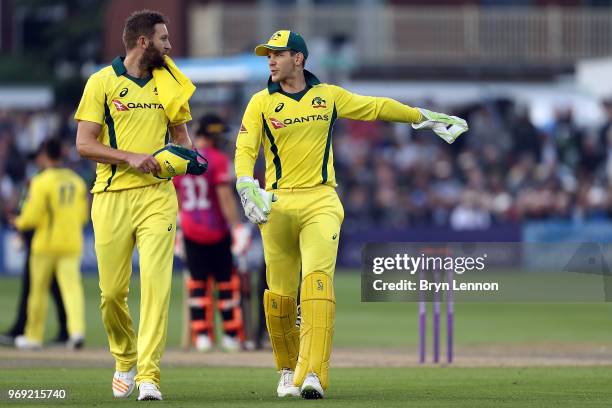 Tim Paine of Australia chats to team mate Andrew Tye during the one day tour match between Sussex and Australia at The 1st Central County Ground on...
