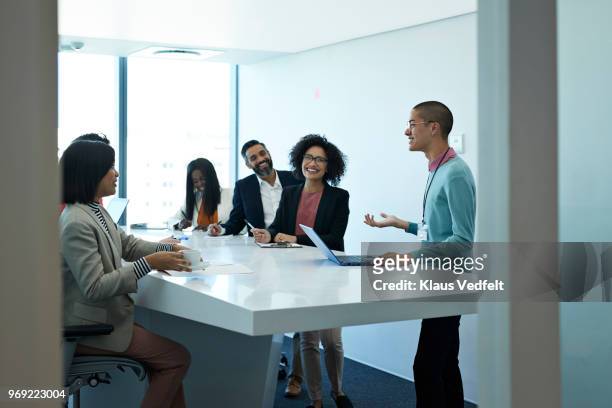 businesspeople having standing meeting at creative agency - conference table top stock pictures, royalty-free photos & images