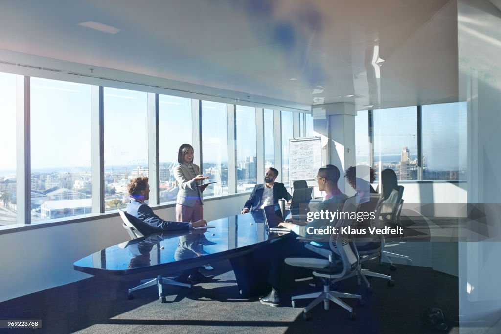 Young entrepreneur presenting project in exclusive boardroom