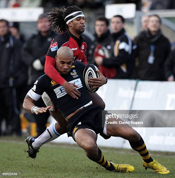 Tom Varndell of Wasps is tackled by Noah Cato during the Guinness Premiership match between London Wasps and Saracens at Adams Park on February 21,...