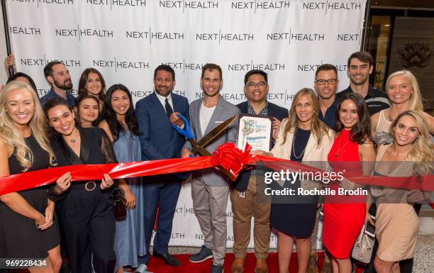 Of Next Health Darshan Shah M.D. And Co-owner of Next Health Kevin Peake cut the ribbon with guests at Next Health Grand Opening at the Westfield,...