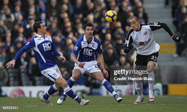 Bobby Zamora of Fulham contests Barry Ferguson and Liam Ridgewell of Birmingham during the Barclays Premier League match between Fulham and...