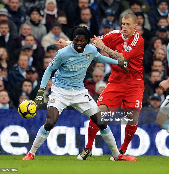 Martin Skrtel of Liverpool competes with Emmanuel Adebayor of Manchester City during the Barclays Premier League match between Manchester City and...