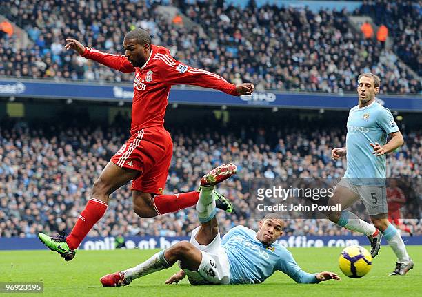 Ryan Babel of Liverpool competes with Nigel de Jong of Manchester City during the Barclays Premier League match between Manchester City and Liverpool...